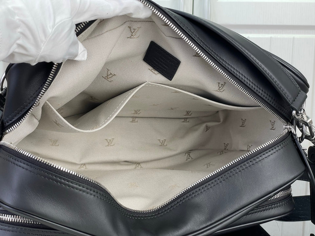 Louis Vuitton bag interior with patterned lining and black zipper pocket