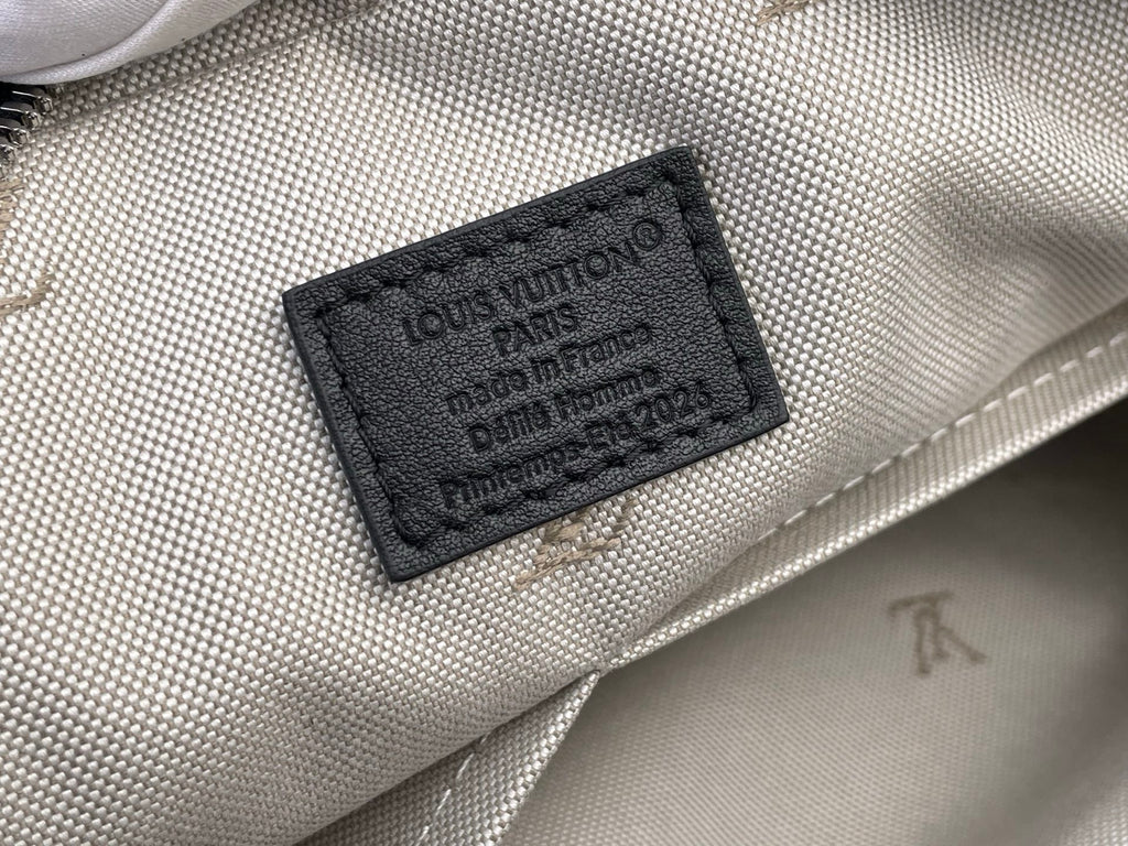 Louis Vuitton bag label patch on light patterned fabric lining