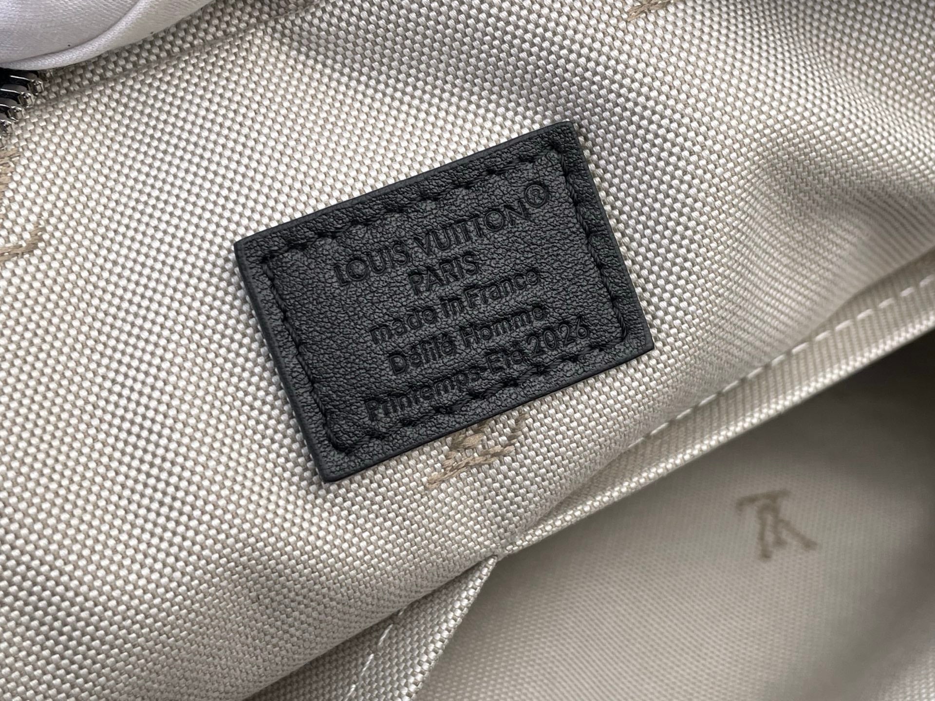 Louis Vuitton bag label patch on light patterned fabric lining