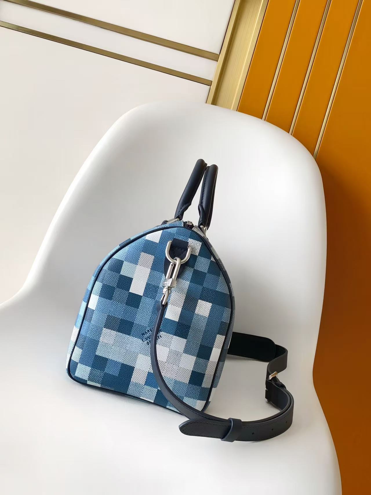 Blue checkered mini handbag with zip top, top handle, and crossbody strap