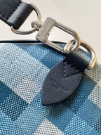 Black leather strap with silver-tone D-ring on blue checkered handbag