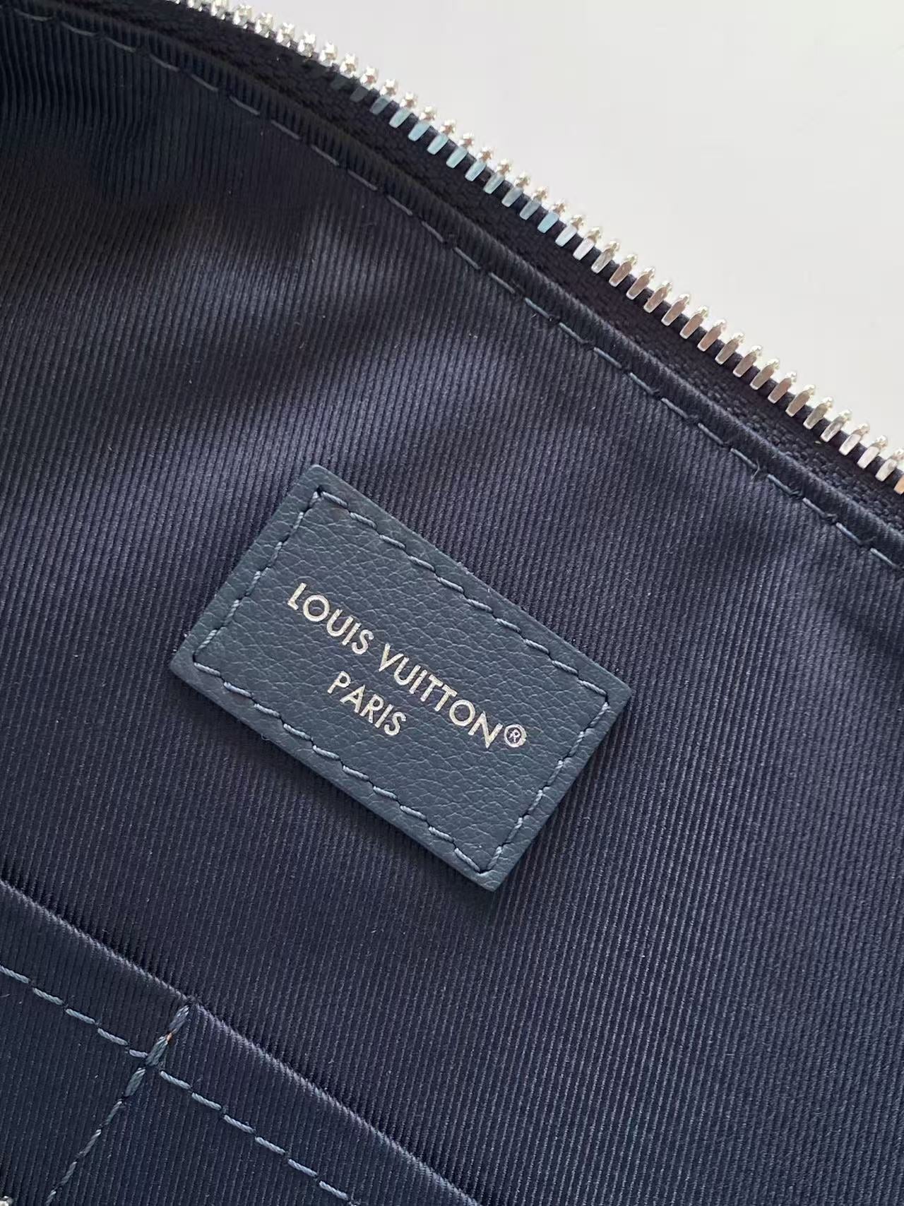 Louis Vuitton Paris label on dark interior pocket with zipper