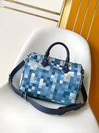 Blue checkered handbag with arched top handles and navy shoulder strap