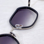 Bottega Veneta sunglasses close-up with dark lenses and black frame