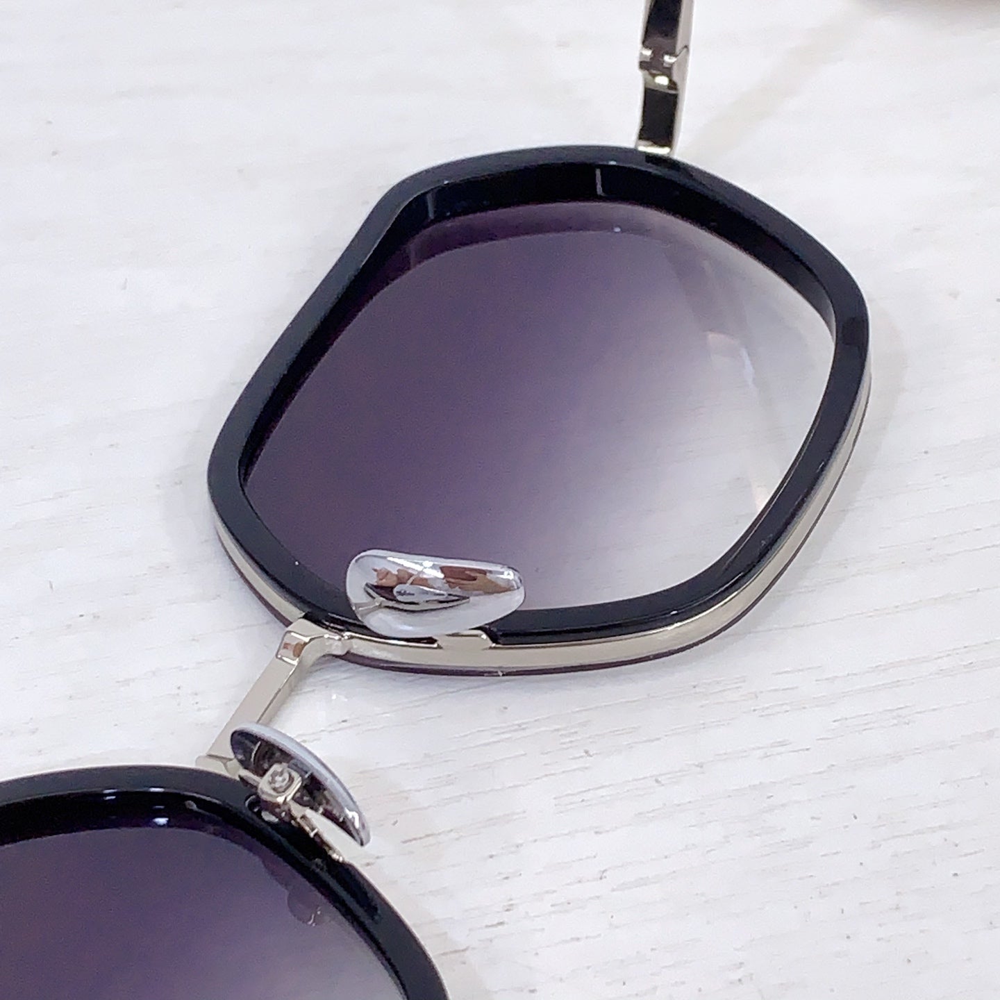 Bottega Veneta sunglasses close-up with dark lenses and black frame