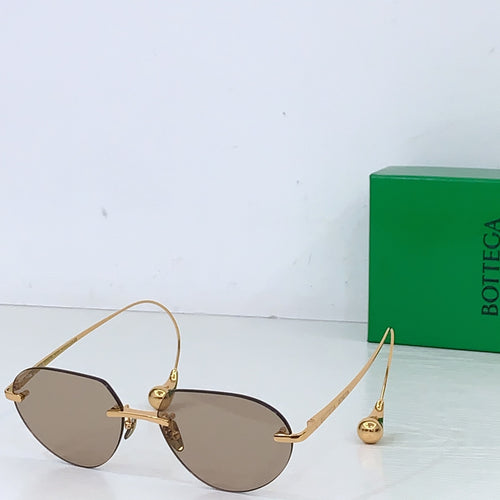 Gold-tone round sunglasses with brown gradient lenses and adjustable hinge arms