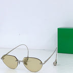 Gold-tone round sunglasses with amber lenses and thin metal temple arms