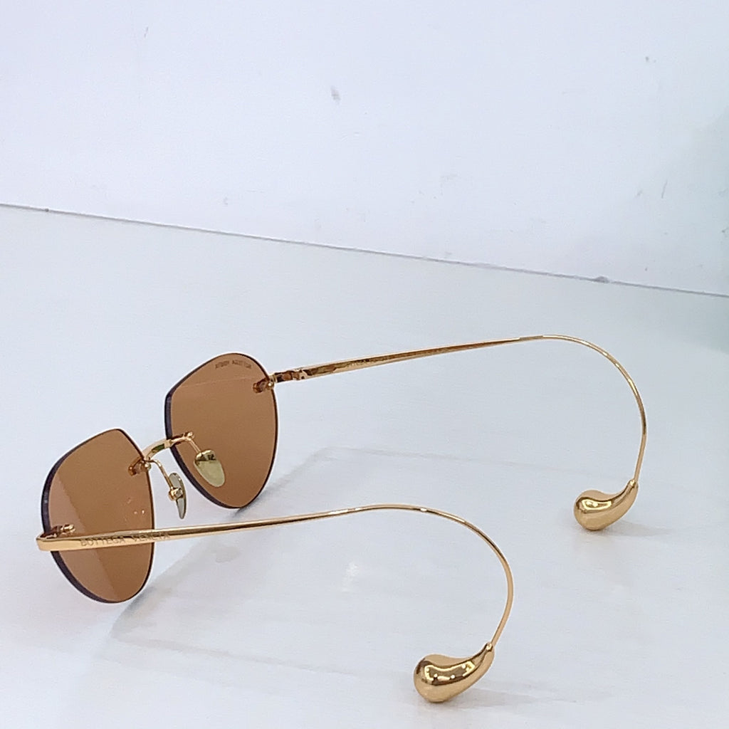 Gold-tone round sunglasses with light brown lenses and thin metal temples