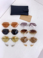 Assorted gold-tone round sunglasses with mixed lens colors, shown together
