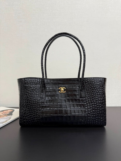 Chanel leather tote bag in dark croc texture with top handles and gold CC clasp
