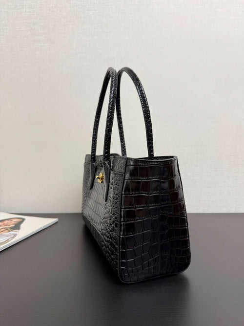 Black croc-texture tote bag with two top handles and gold hardware detail