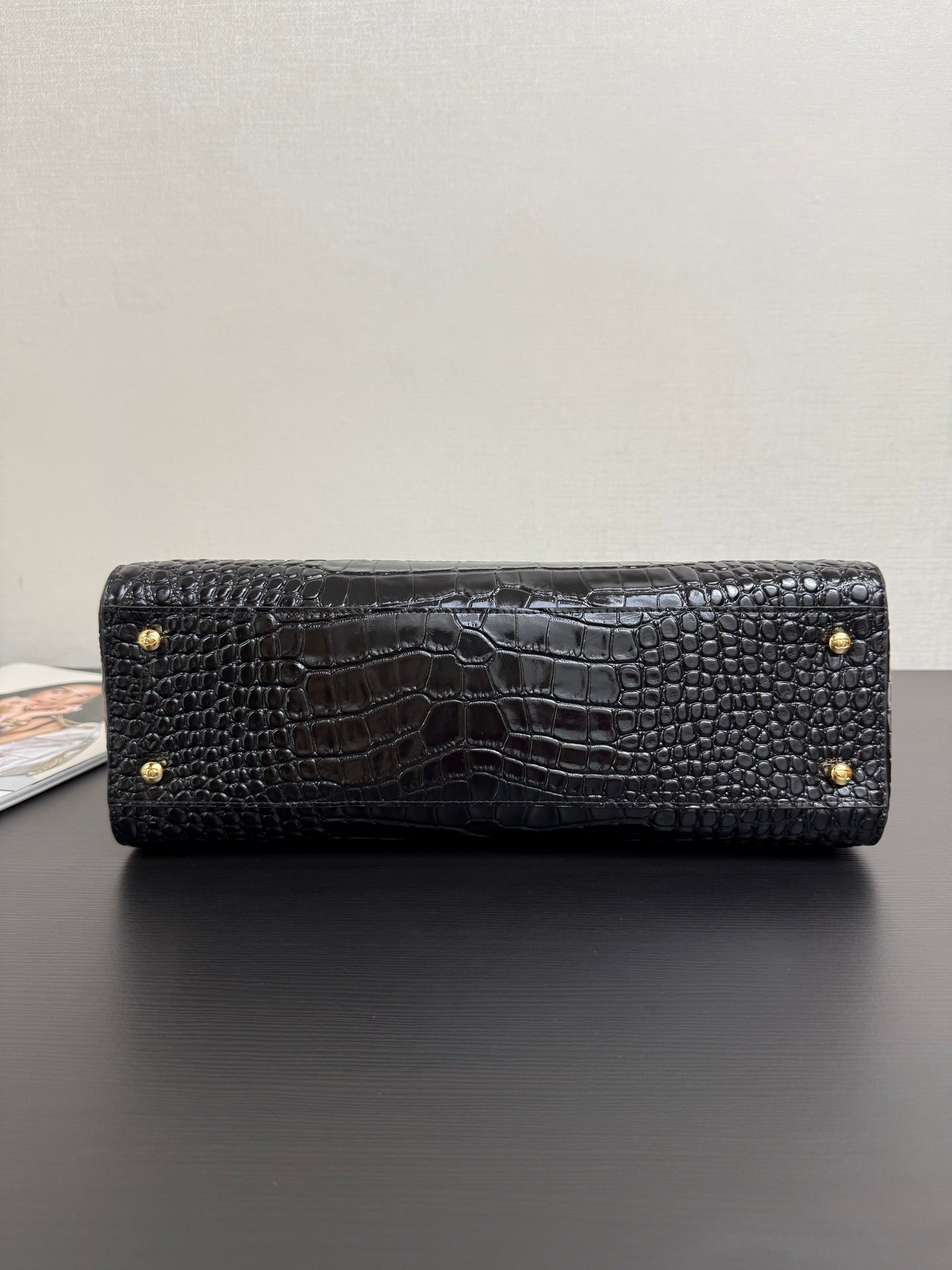 Black croc-texture Chanel bag with top flap and gold snap buttons