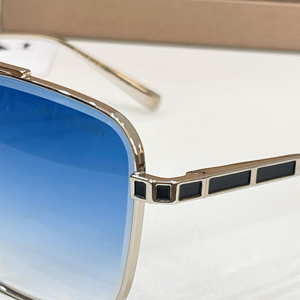 Bvlgari square sunglasses close-up: gold-tone frame with black geometric inlays