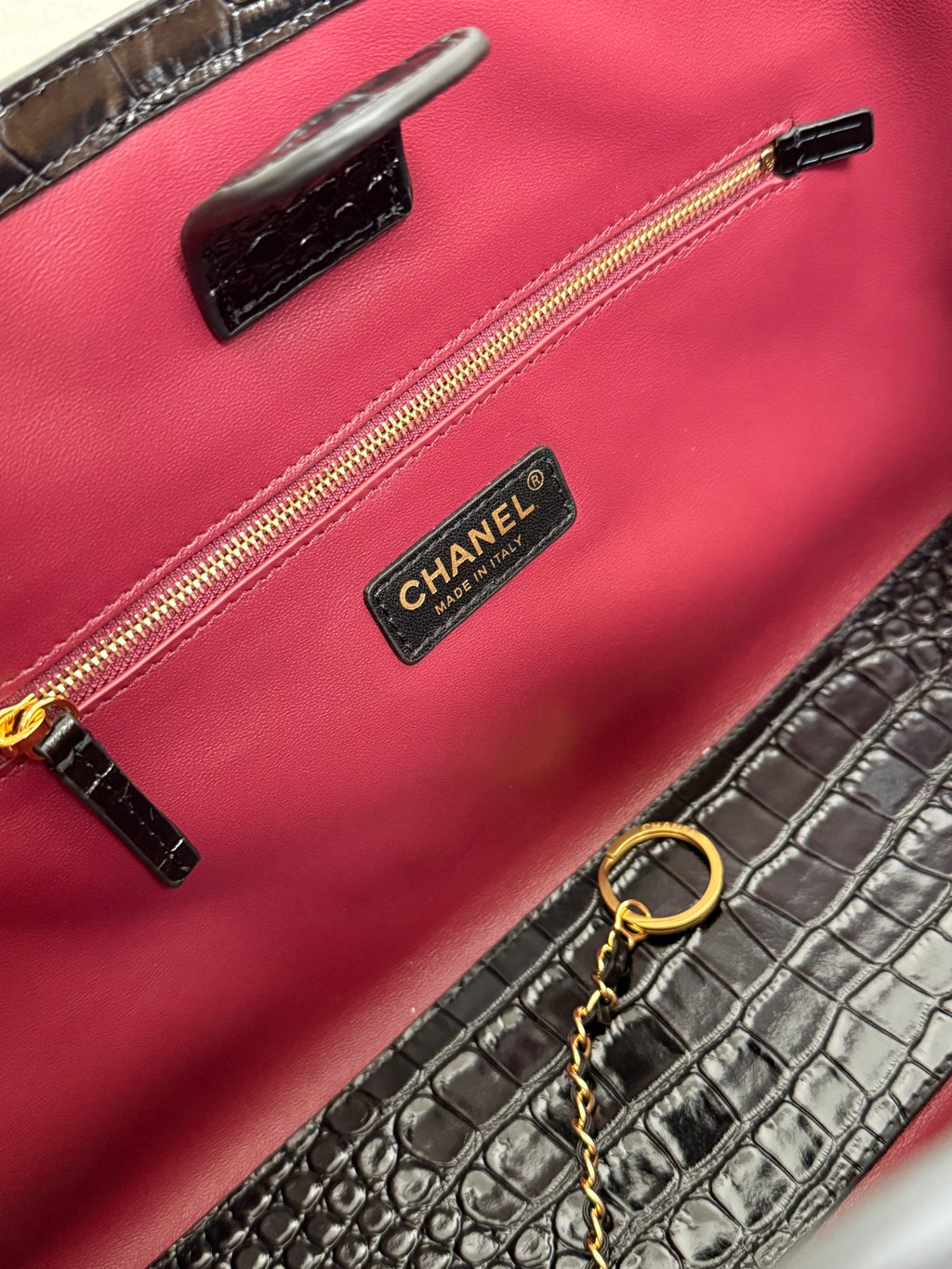 Pink Chanel bag interior with zip pocket and CHANEL logo label