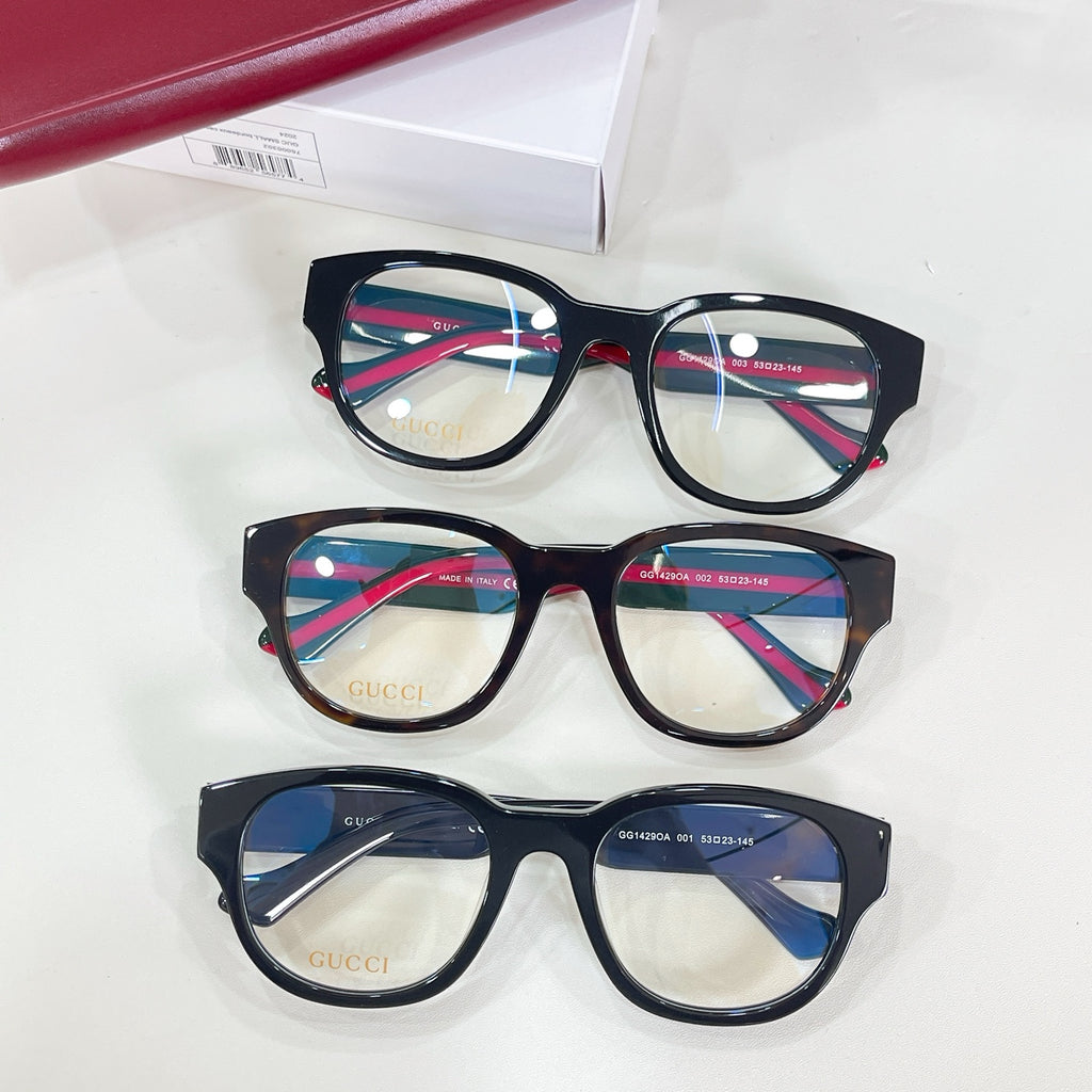 Set of three black glasses frames with green-and-red striped temples and clear lenses