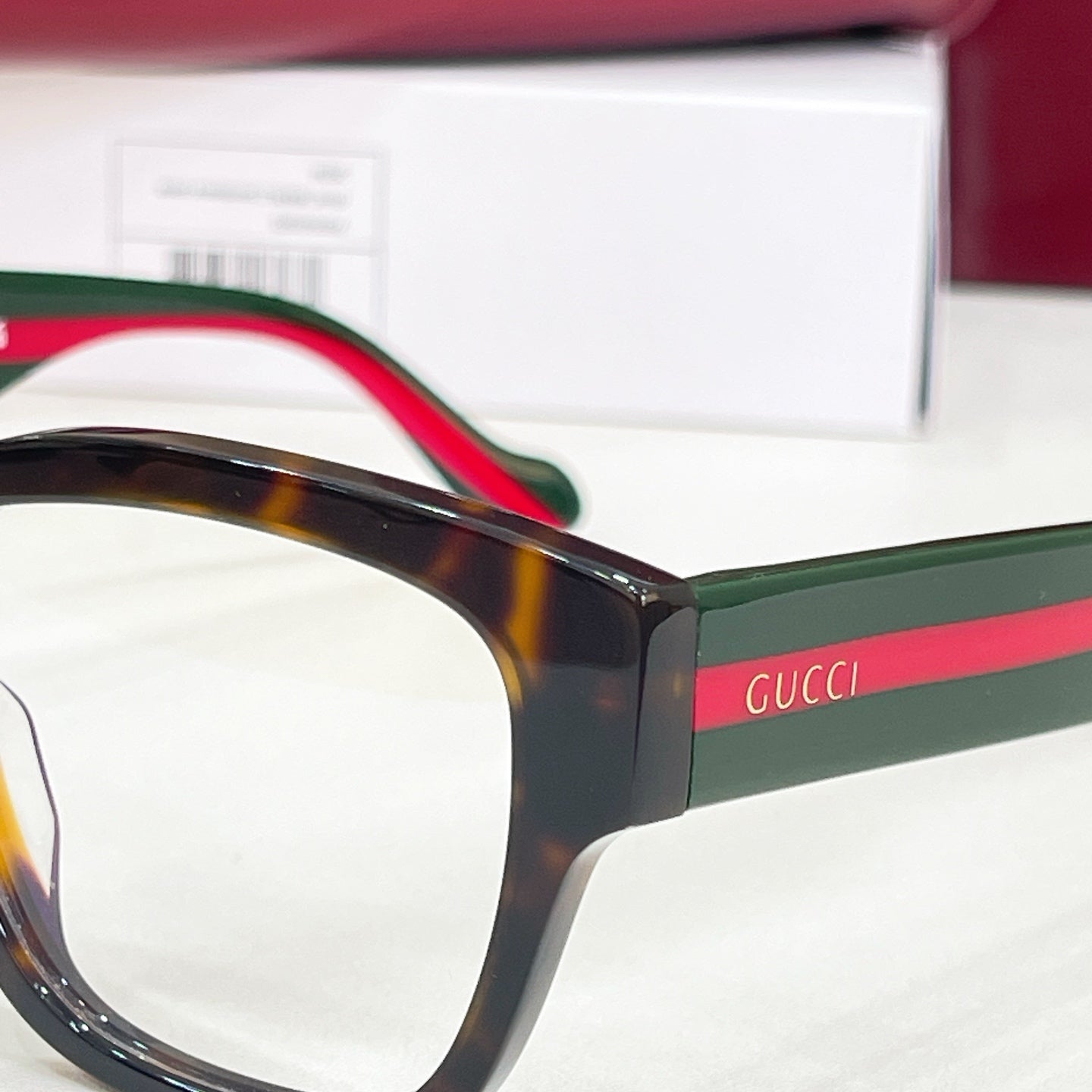 Gucci glasses close-up of temple arm with green and red stripe accents