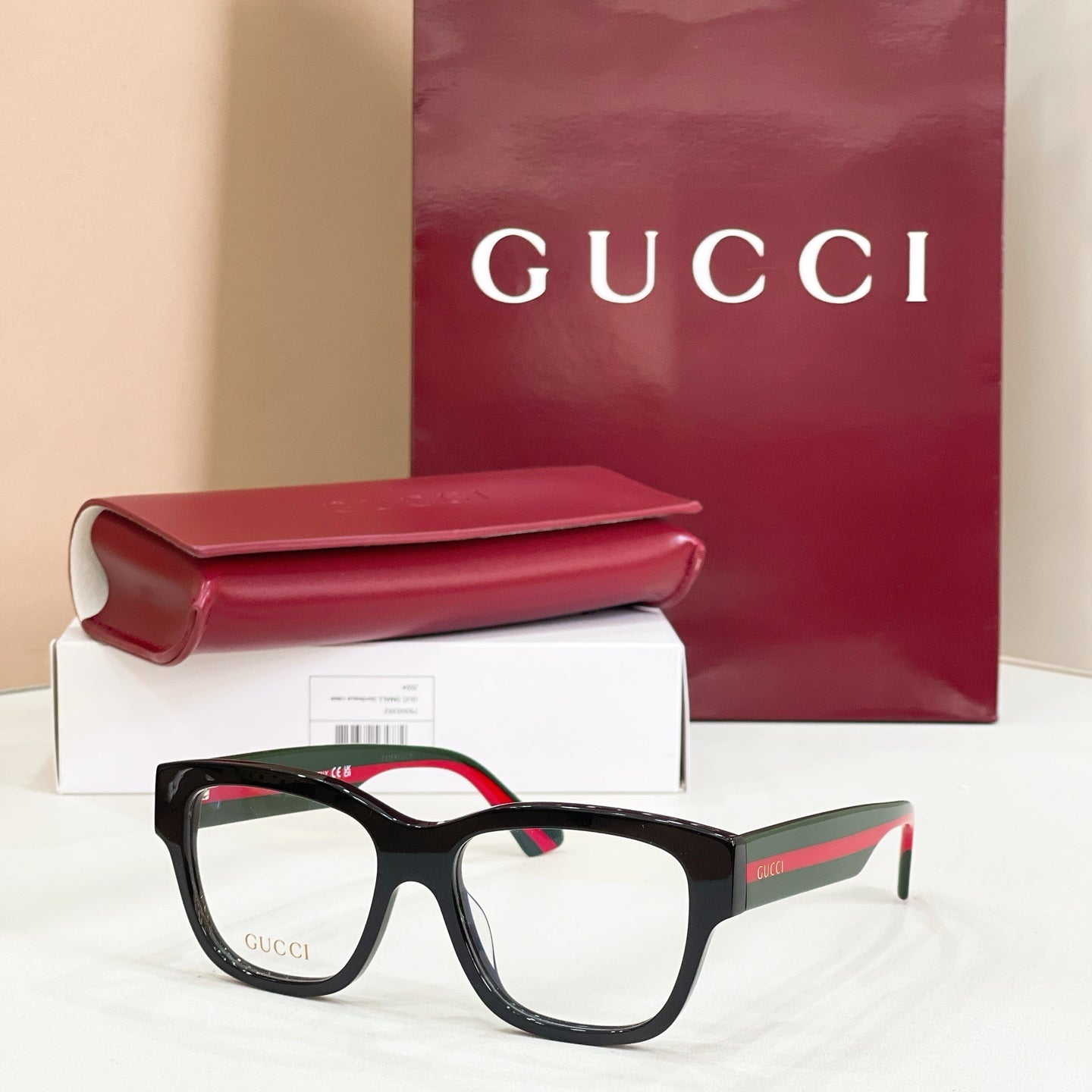 Gucci glasses with dark frames and clear lenses, multicolor side stripe on temples