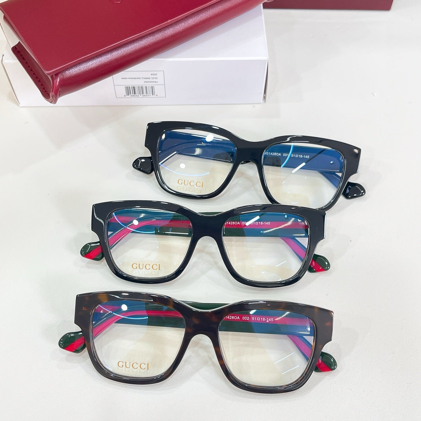 Gucci glasses set of three with black frames and multicolor temple stripe details