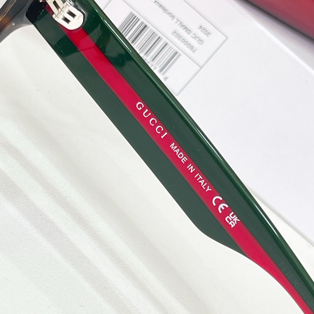 Gucci glasses close-up of green temple arm with “Gucci” and “Made in Italy” text