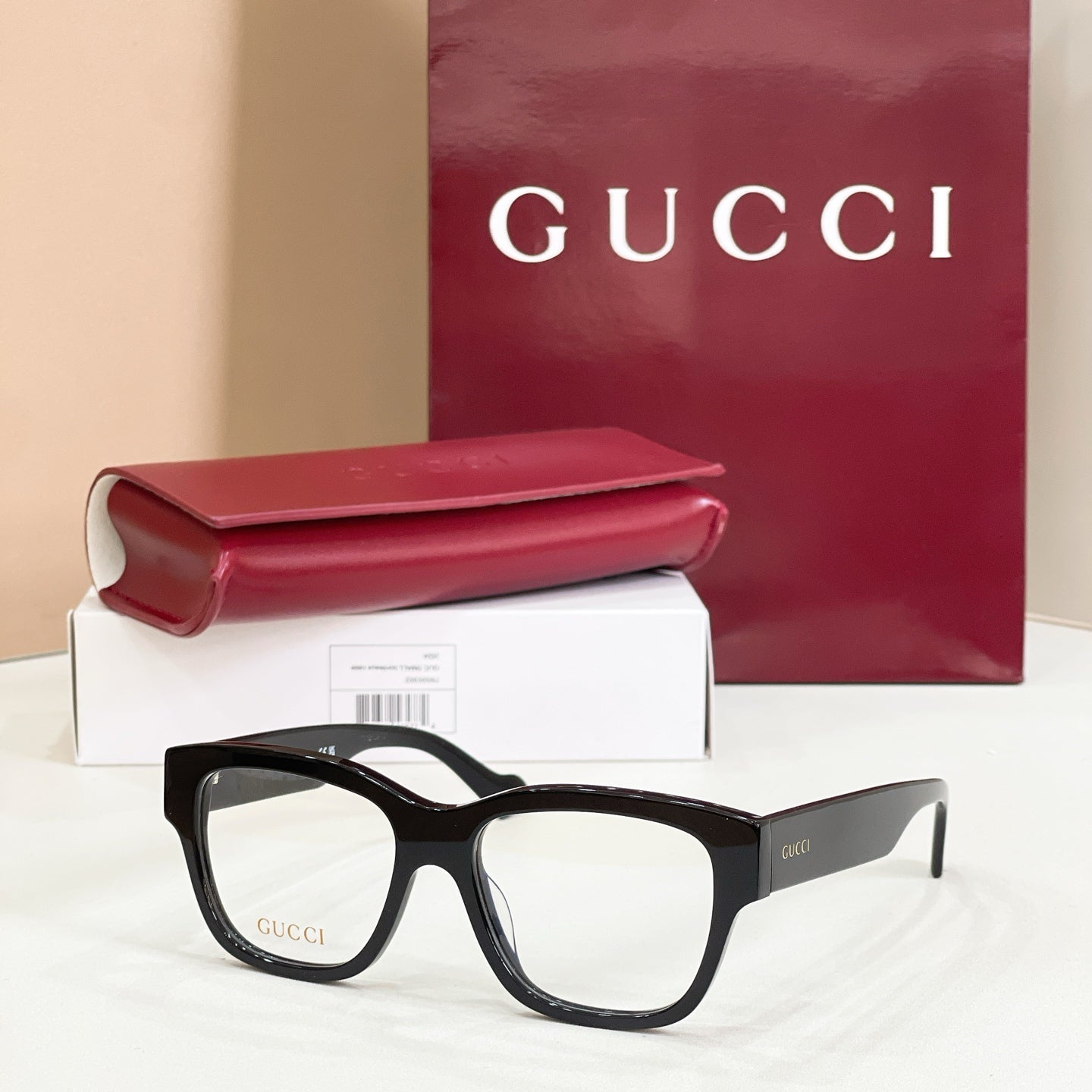 Gucci glasses with black rectangular frames and clear lenses, dark temple arms