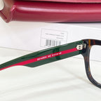 Gucci glasses side view, green temple with red and white logo text