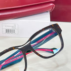 Gucci glasses close-up of tortoiseshell frame with blue and pink temple stripe