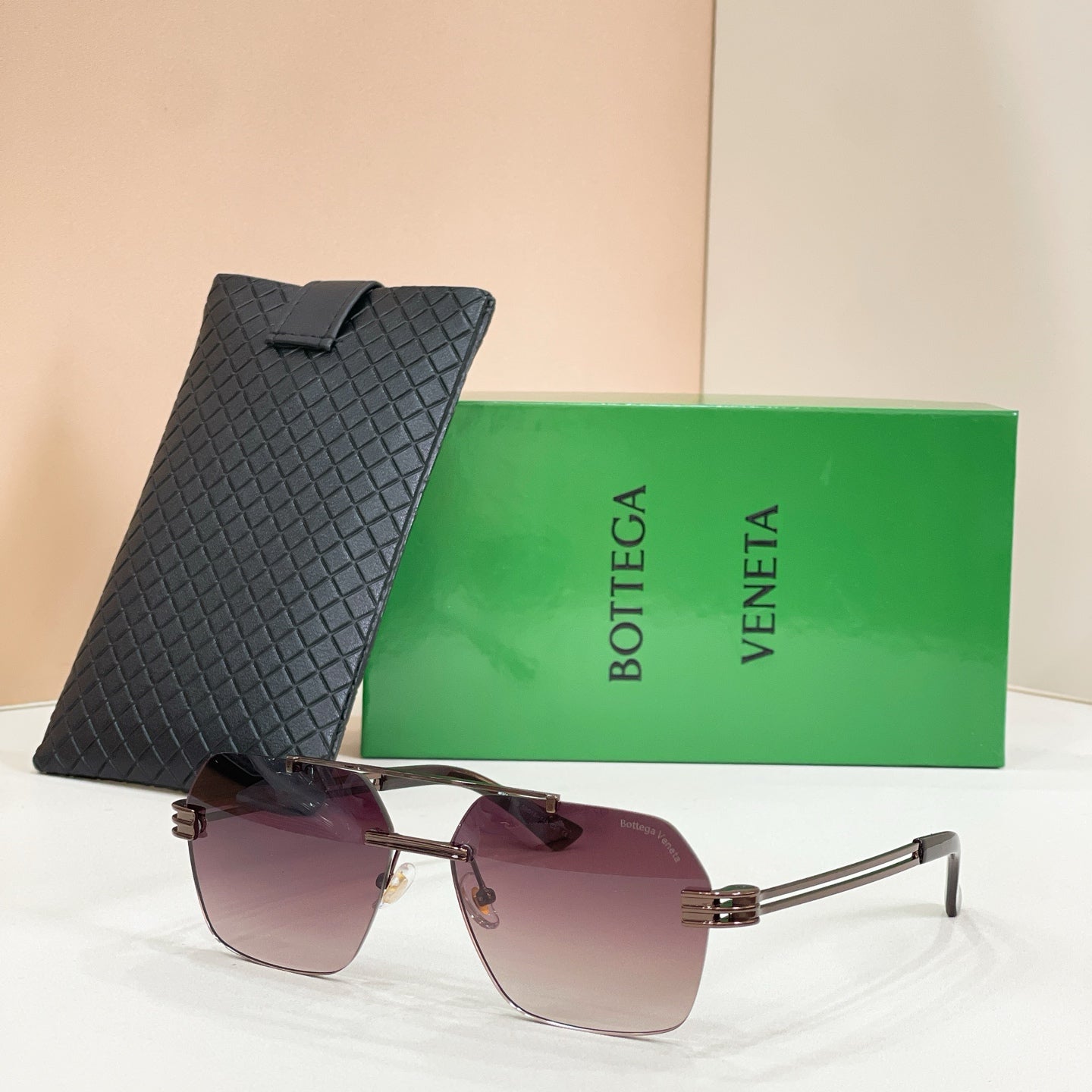 Bottega Veneta aviator sunglasses, maroon-to-clear gradient lenses, silver-tone frame, textured black case