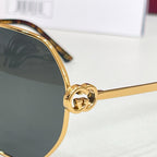 Gucci sunglasses temple detail with gold logo and dark tinted lens