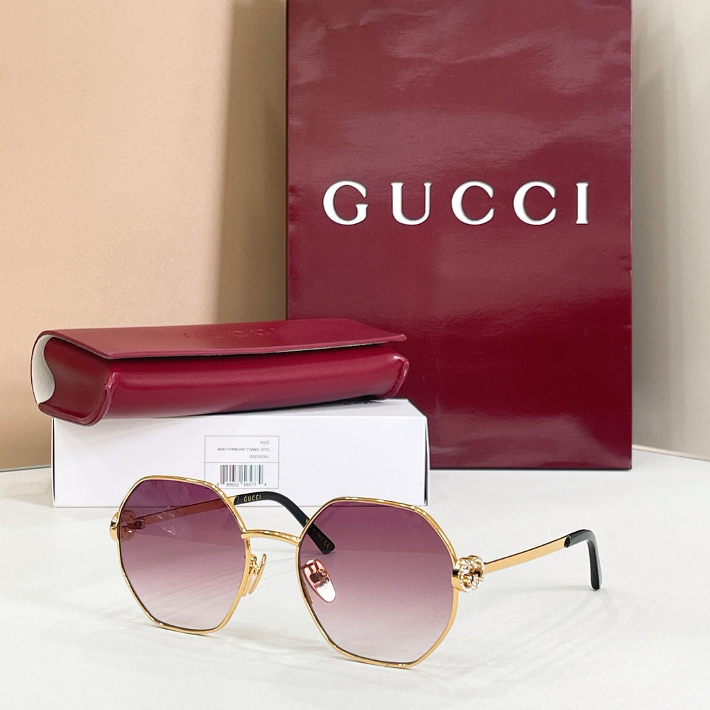 Gucci sunglasses with gold-tone round frames, black arms, purple gradient tinted lenses
