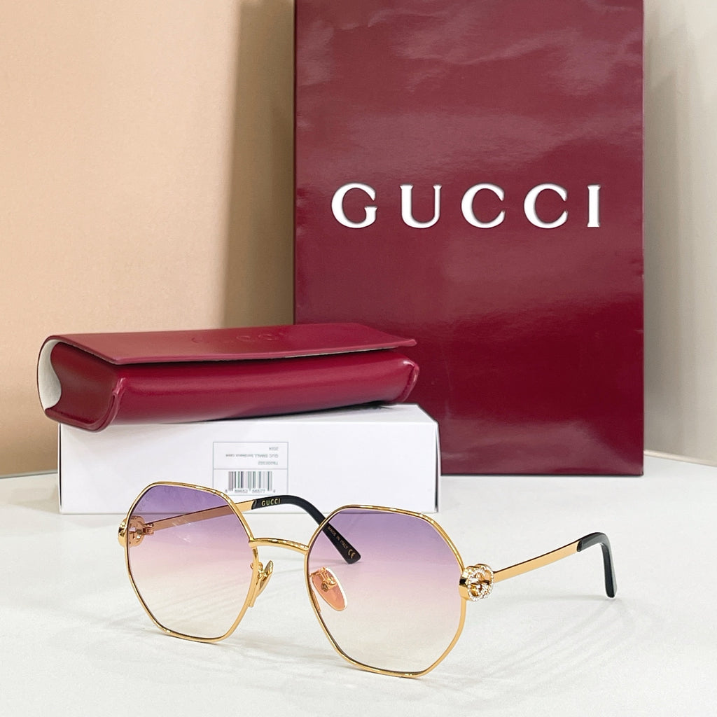 Gucci sunglasses with gold-tone round frames, black arms, purple gradient tinted lenses