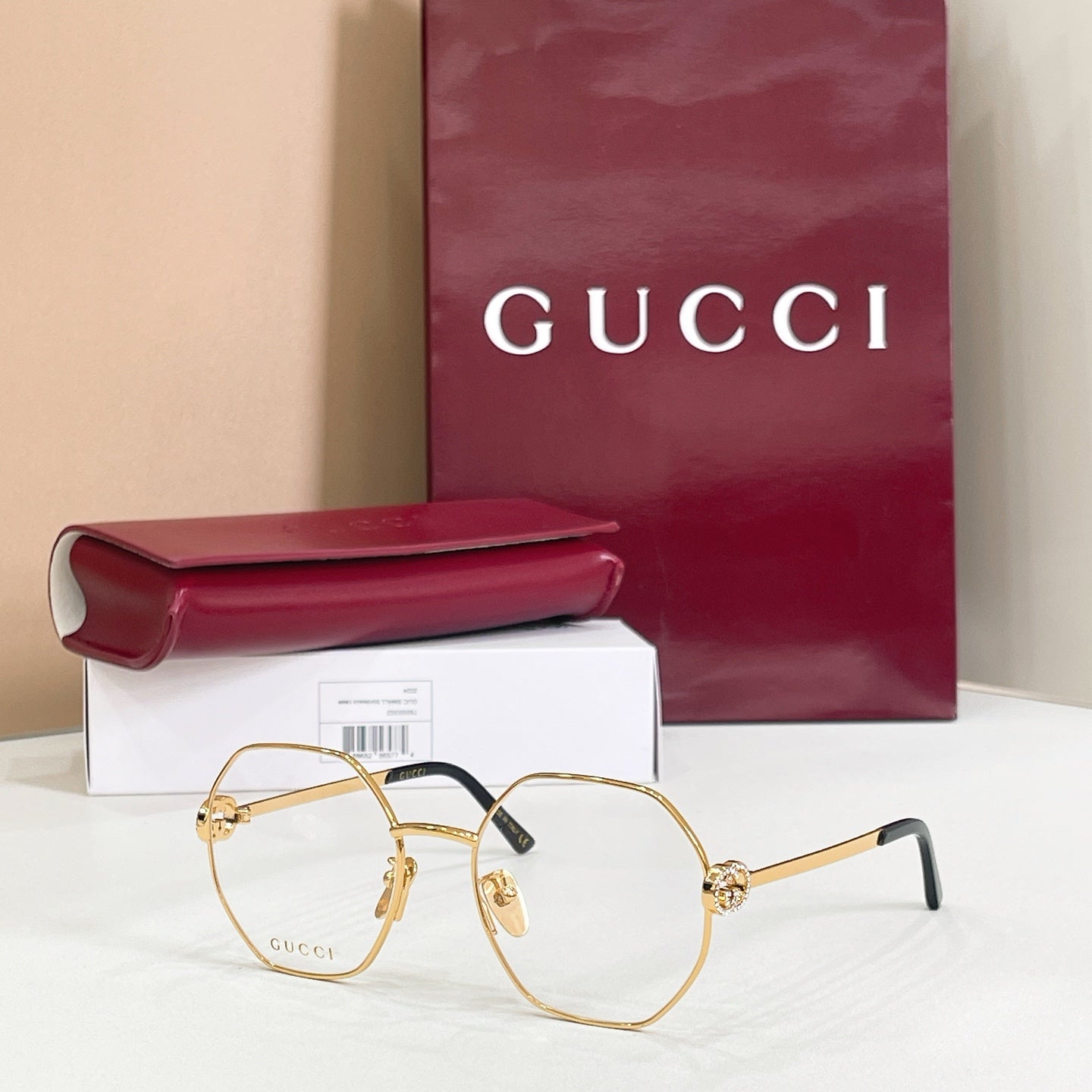 Gucci sunglasses with gold-tone round frames, black arms, tinted lenses