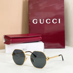 Gucci sunglasses with gold-tone round frames, black arms, dark gray tinted lenses
