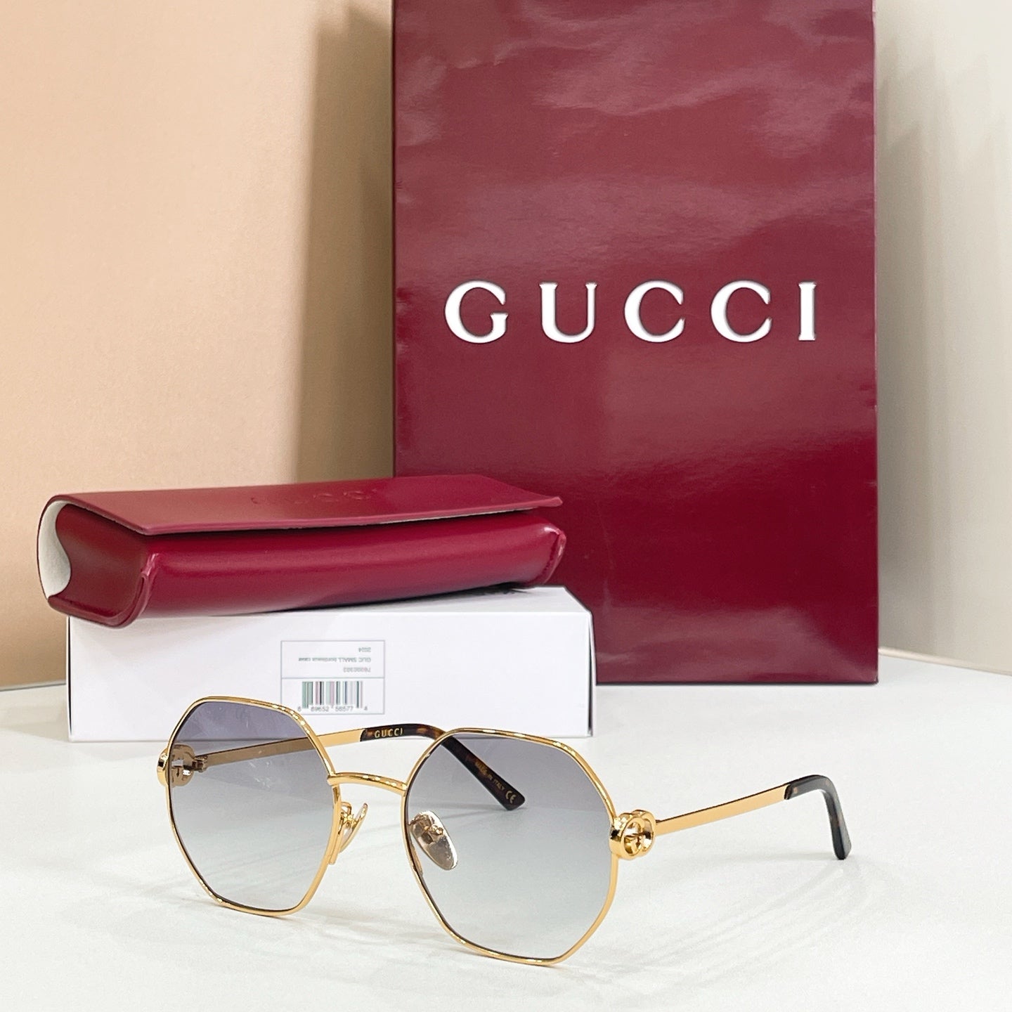 Gucci sunglasses with gold-tone round frames, black arms, light gradient tinted lenses