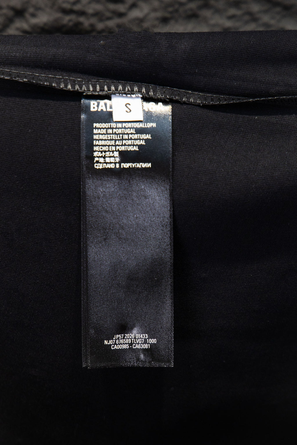 Black short-sleeve T-shirt with size and care label inside hem