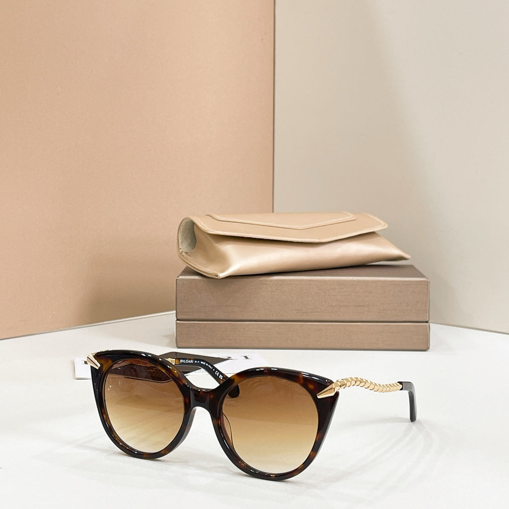 Brown tortoiseshell cat-eye sunglasses with gold chain arms and amber-tinted lenses