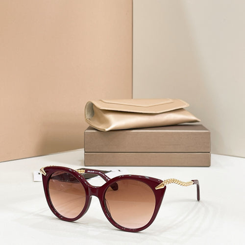 Burgundy cat-eye sunglasses with gold chain arms and tinted lenses