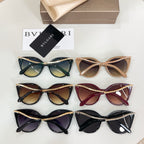 Assorted cat-eye sunglasses in green, tan, burgundy, and black with gold chain arms