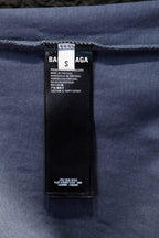 Balenciaga T-shirt inner care label tag on light blue fabric