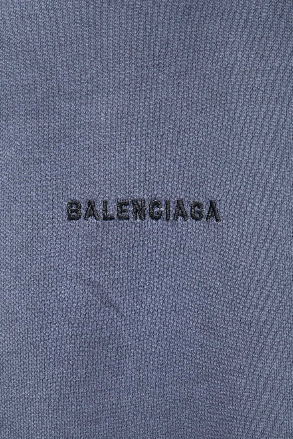 Balenciaga T-shirt fabric close-up with black BALENCIAGA logo print