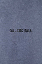 Balenciaga T-shirt fabric close-up with black BALENCIAGA logo print