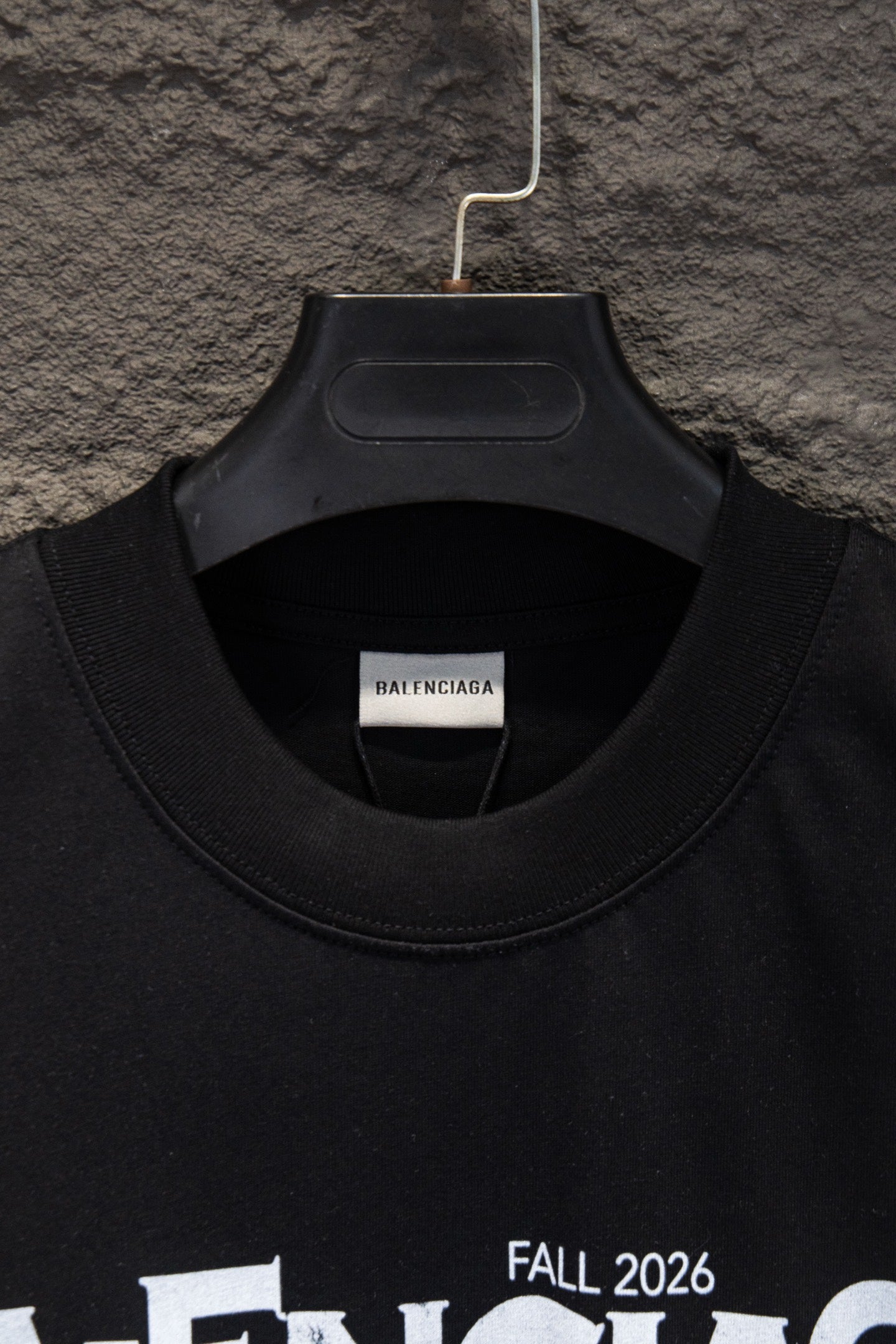 Black T-shirt collar close-up with crew neck stitching