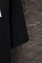 Black T-shirt sleeve and hem with visible stitching