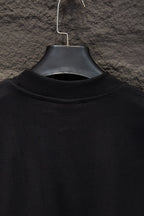 Black short-sleeve T-shirt collar view on hanger
