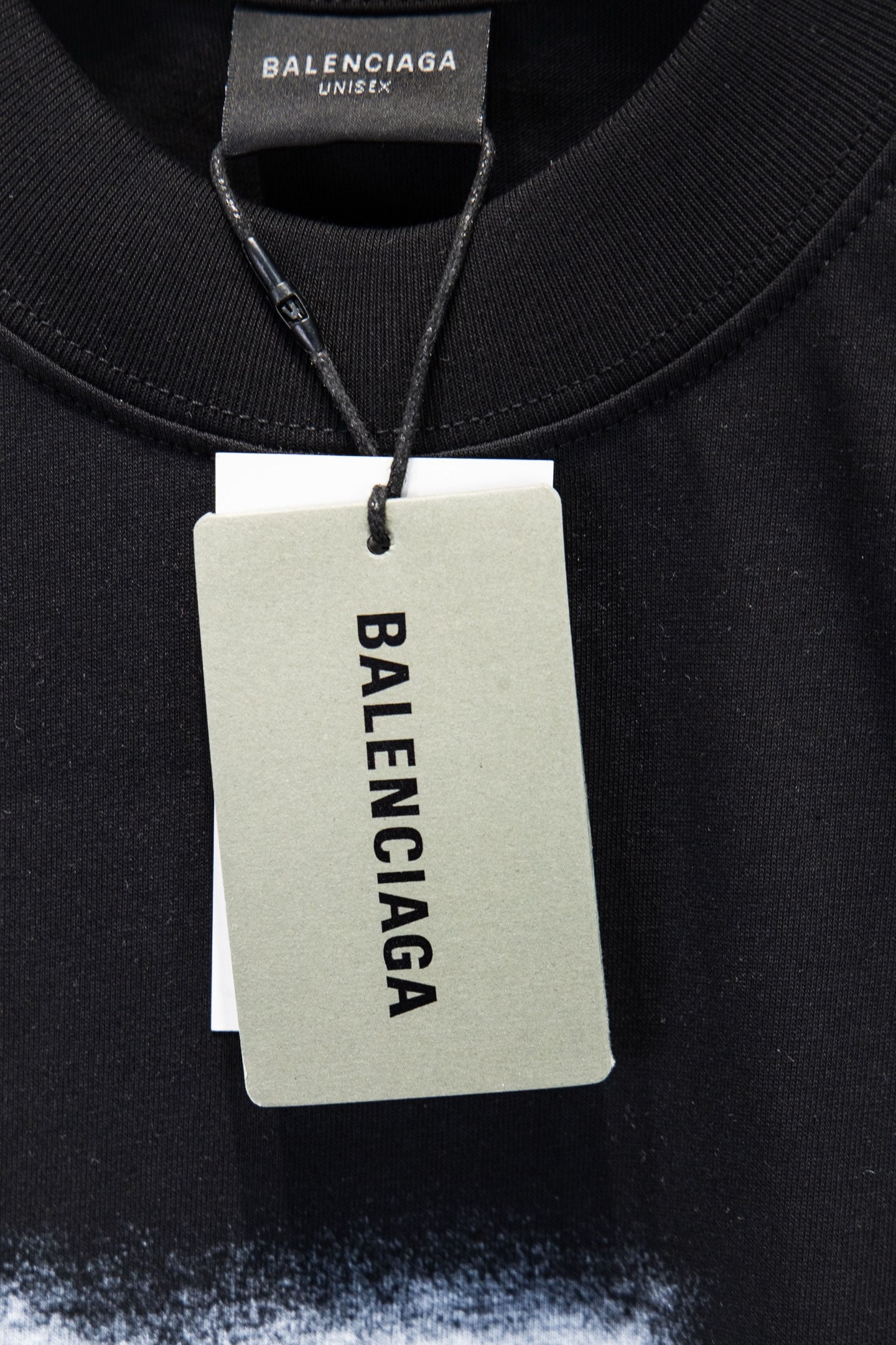 Black short-sleeve T-shirt with Balenciaga logo hang tag at neckline