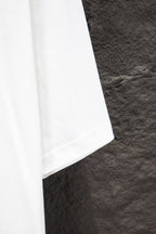 Balenciaga white T-shirt lower side seam, partial view