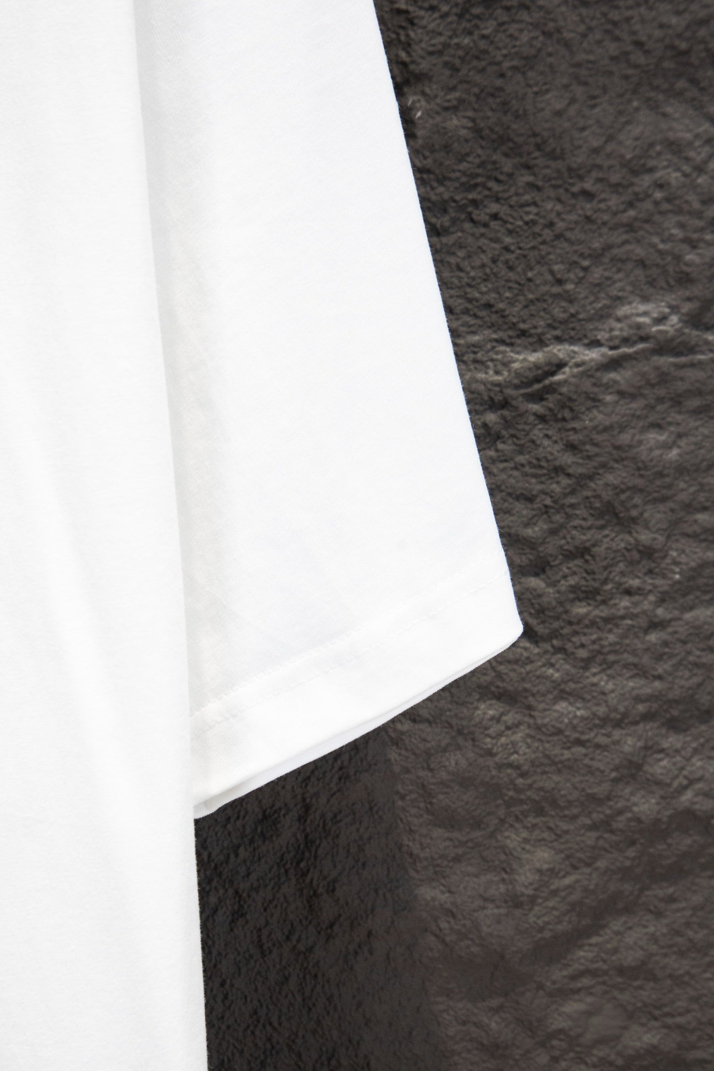 Balenciaga white T-shirt lower side seam, partial view
