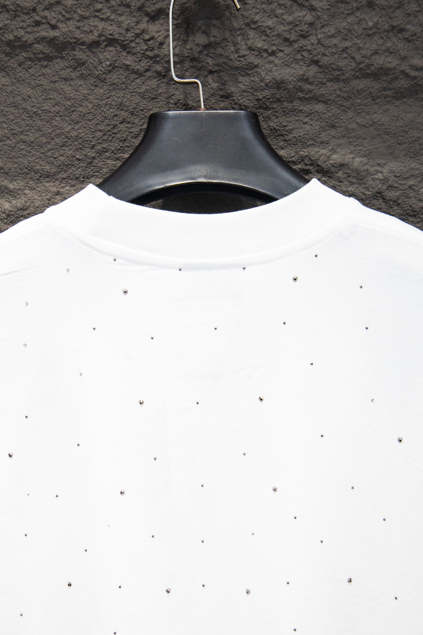 White shirt back neckline with scattered stud-like dots