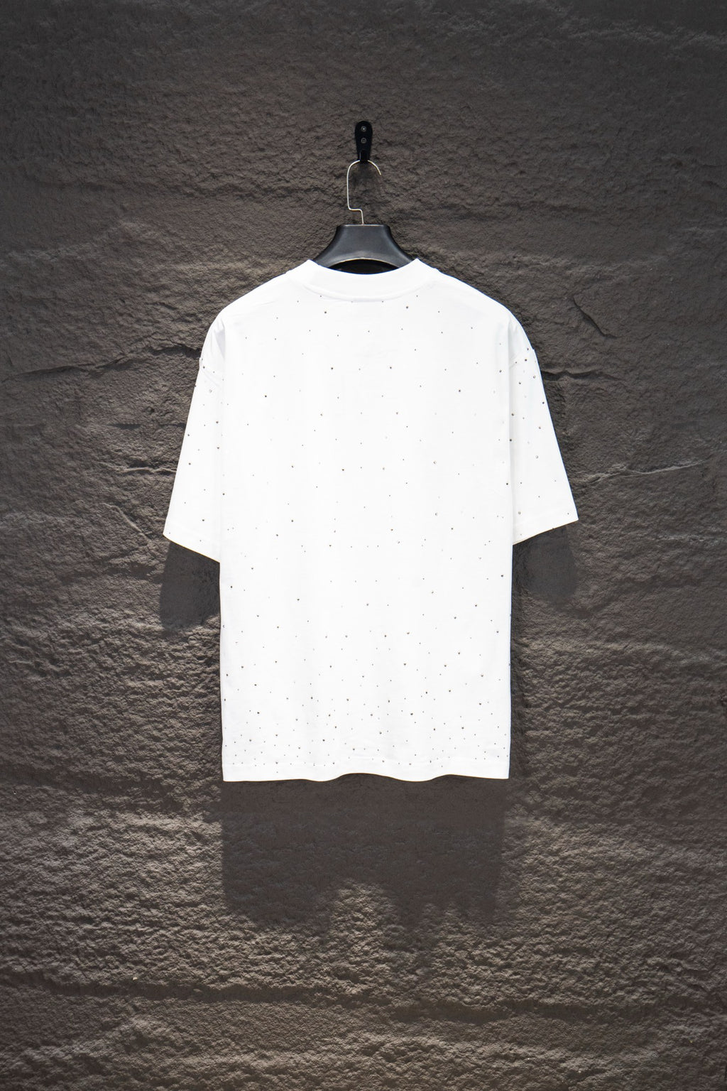 White short-sleeve crewneck shirt with scattered stud-like dots on the torso