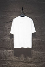 White short-sleeve crewneck shirt with scattered stud-like dots on the torso