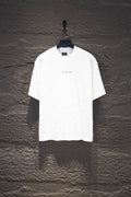 White short-sleeve crewneck shirt with tiny stud-like dots and small chest logo